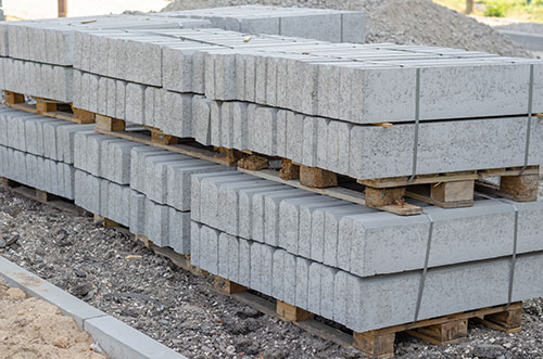 A Stack of New Gray Boarders Stacked on Pallets